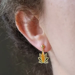 Clous d'oreilles dorées avec un pendant en forme de lotus ajouré de couleur doré et moutarde.