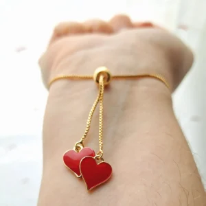 Bracelet réglable avec un coeur doré rouge en pixel et des pampilles en forme de coeurs rouges et dorés